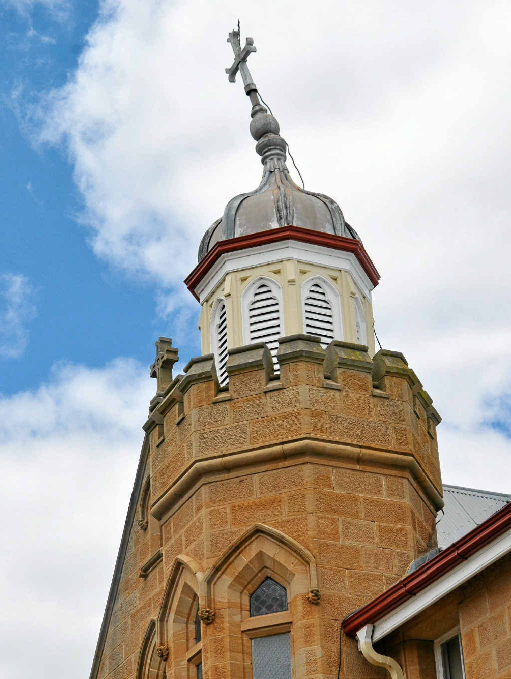 ACT OF GOD: The cross atop the Abbey of the Roses bell tower is on a lean after being struck by lightning. ACT OF GOD: The cross atop the Abbey of the Roses bell tower is on a lean after being struck by lightning.